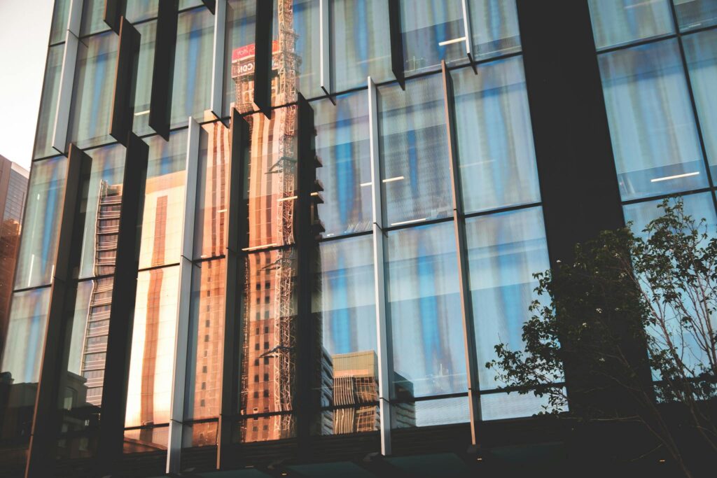 Stunning reflection of urban architecture in a glass facade during daylight.